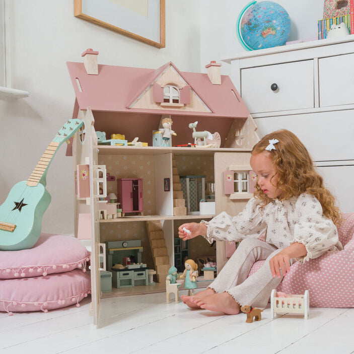 Child playing with a Tender Leaf Toys Alouette dollhouse from toy shop in forster nsw australia