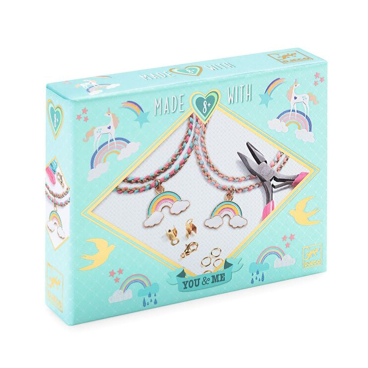 Jewelry-making kit packaging with necklaces, charms, and pliers on a light blue background.