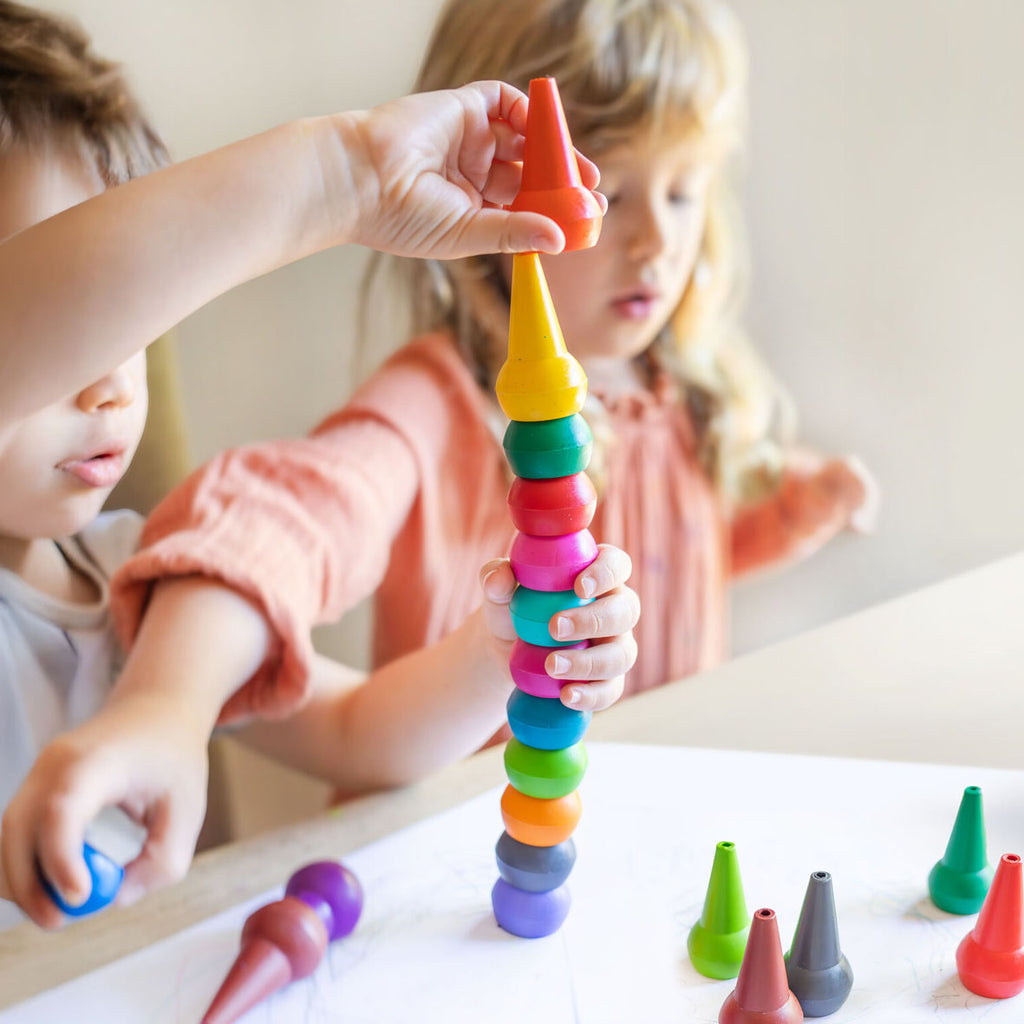 two children playing with tiger tribe candy coloured stackable crayons from australian toy store playdreamers on white 