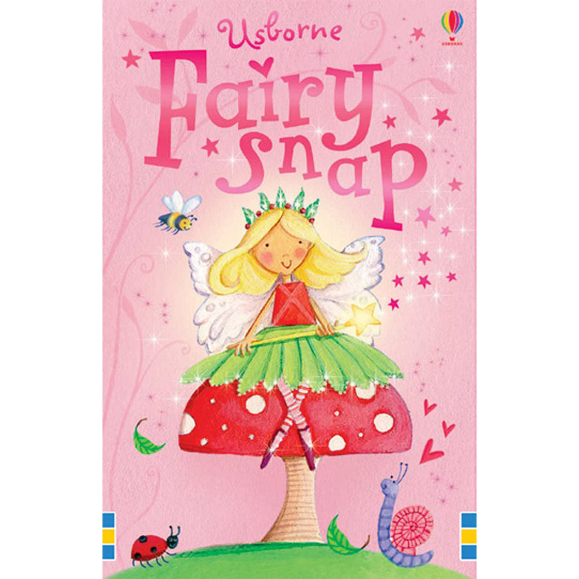 Packaging for 'Fairy Snap' card game by Usborne, featuring a pink box with an illustration of a fairy sitting on a red mushroom with a butterfly, surrounded by stars and a bluebird.